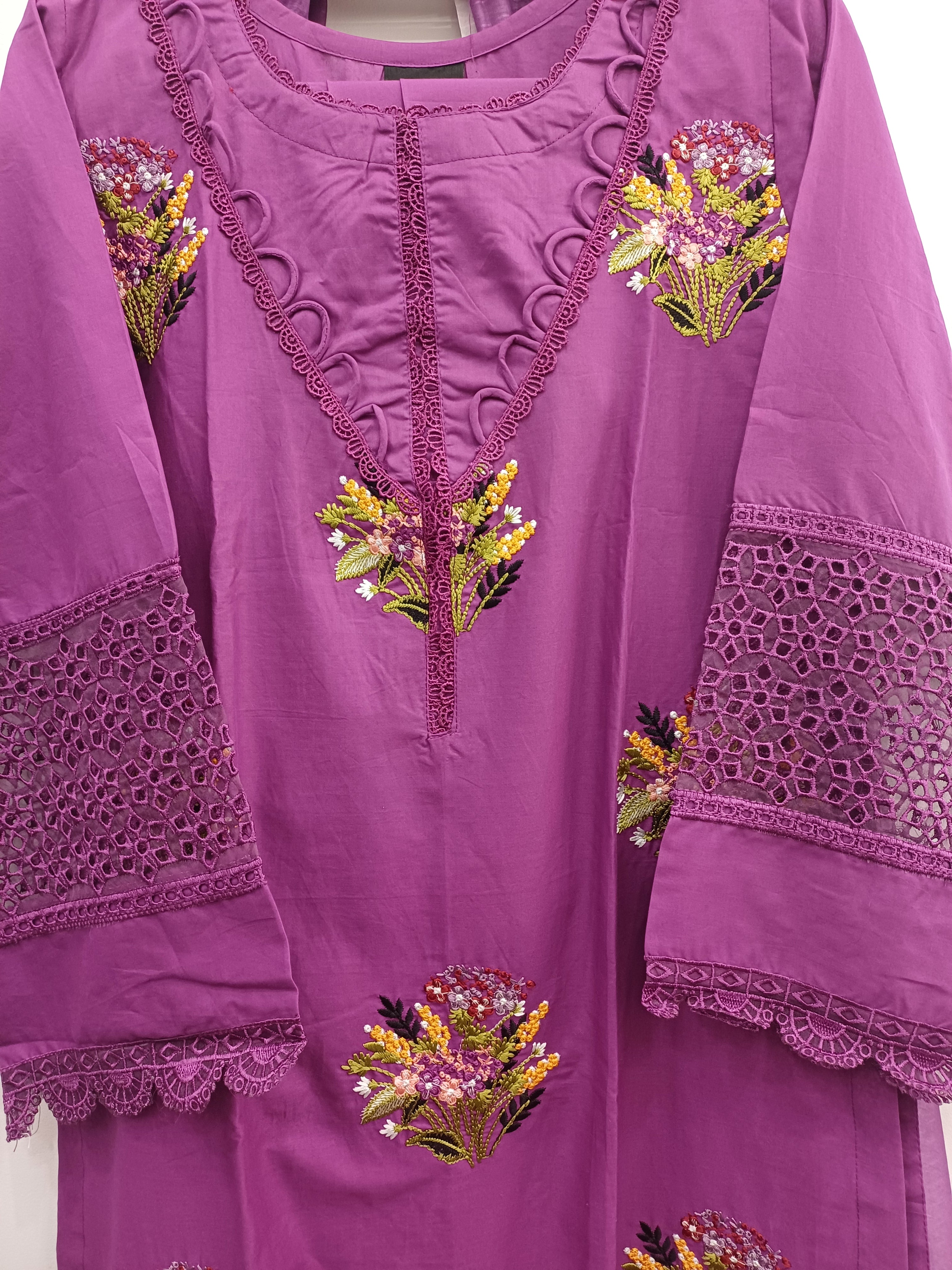 Close-up of purple winter cotton kurta with floral embroidery and lace detailing on neckline and sleeves