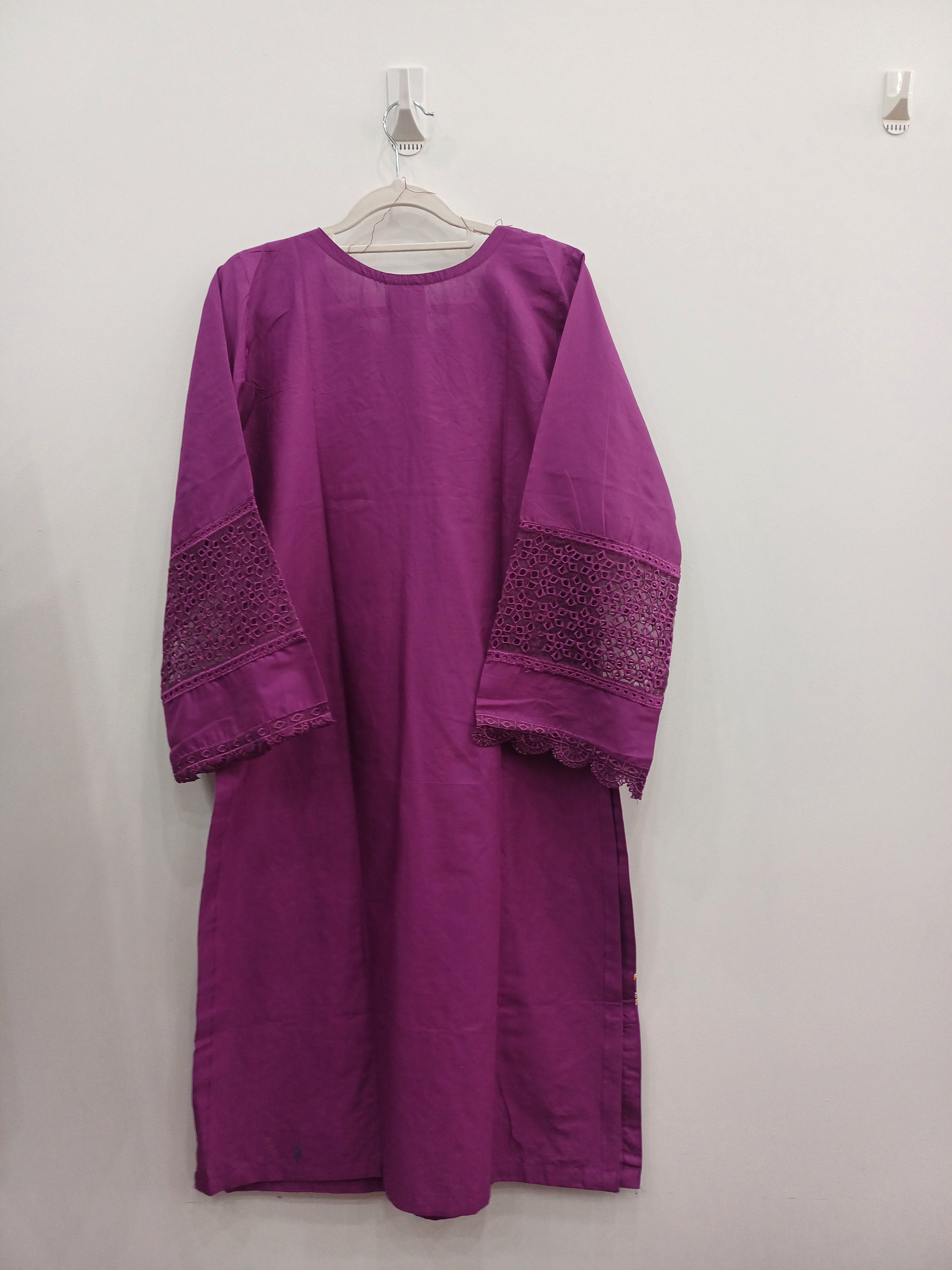 Purple garment with textured details on a white background