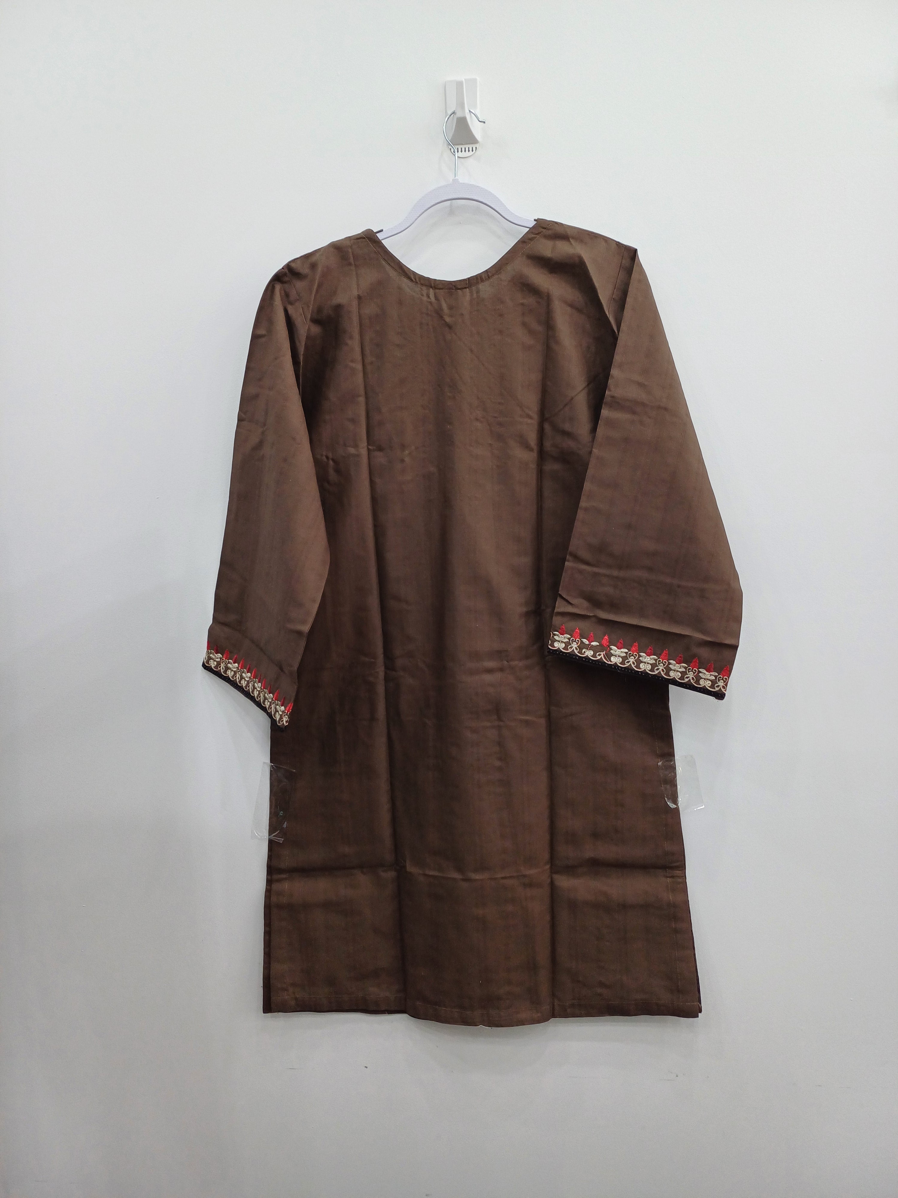 Close-up of neckline embroidery with tassels on winter cotton shirt