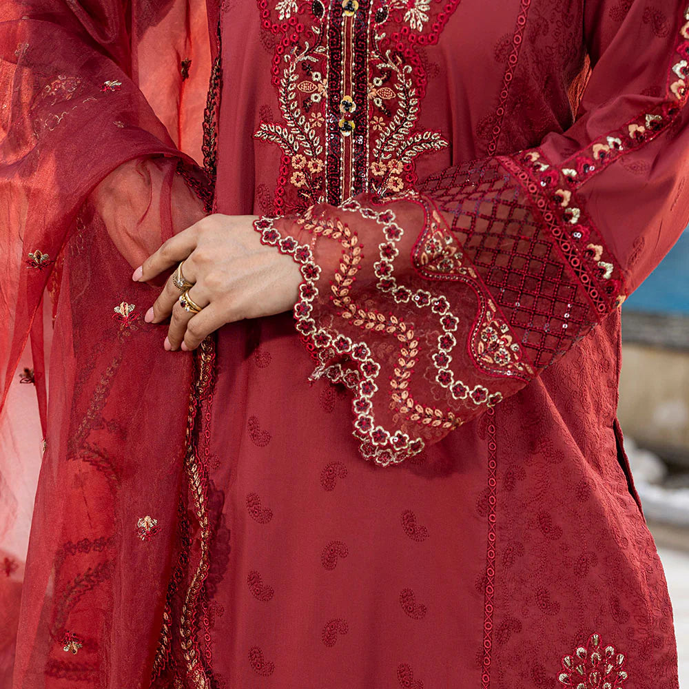 Close-up of a red embroidered garment with gold details