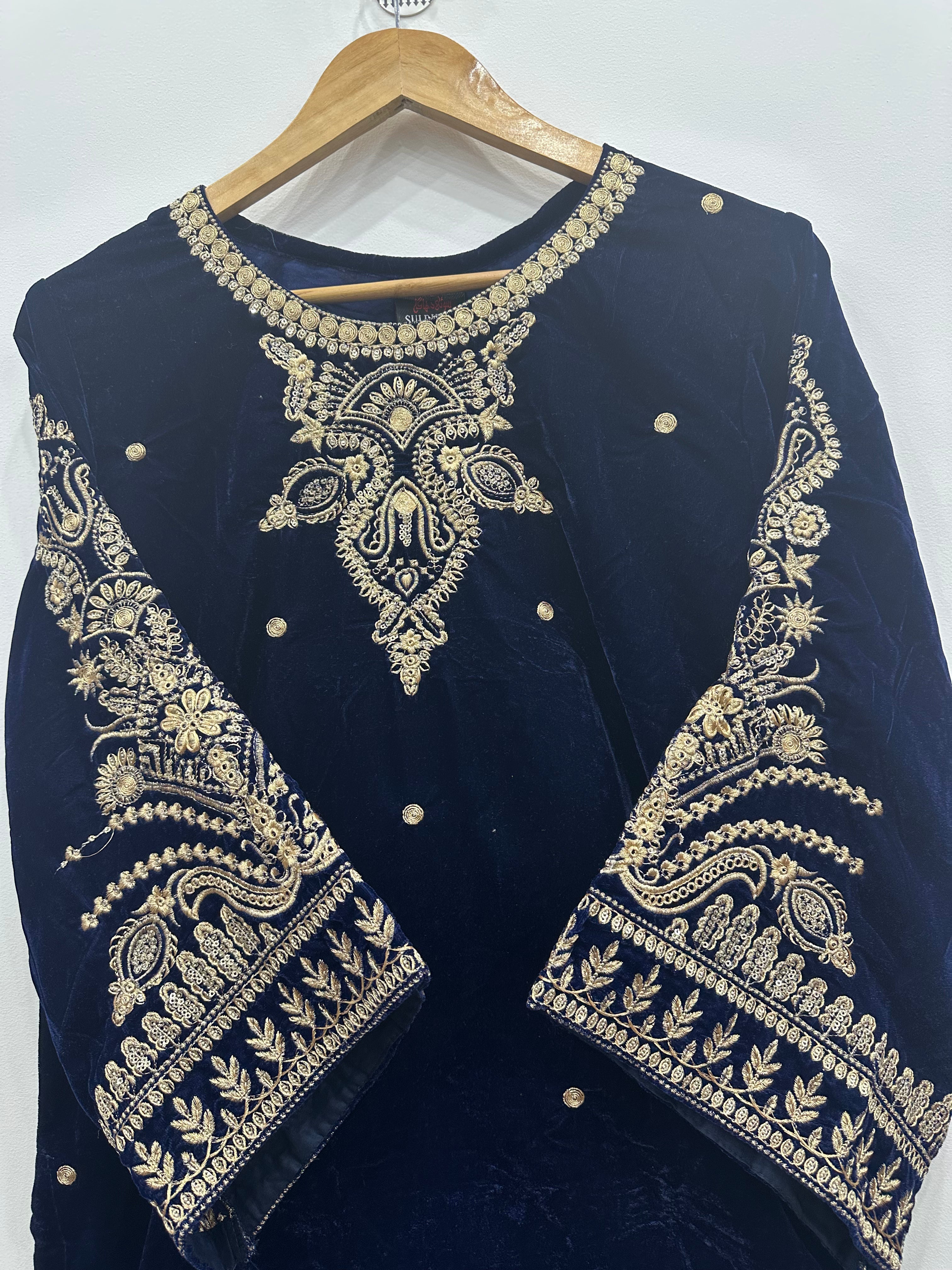 Close-up embroidery on blue velvet kurta neckline and sleeves