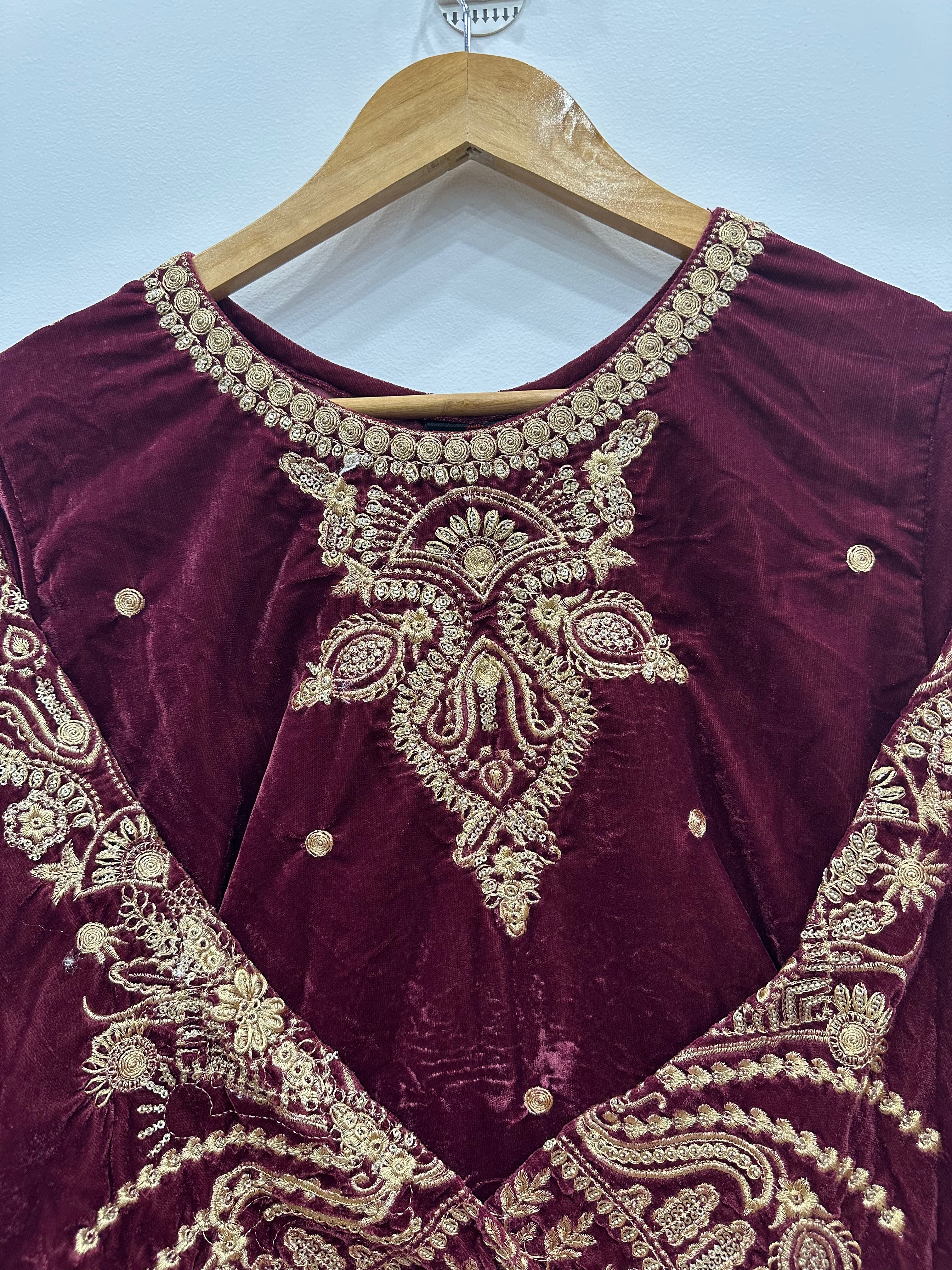 Detailed close-up of maroon velvet kurta heavy embroidery on neckline and sleeves with intricate tila work