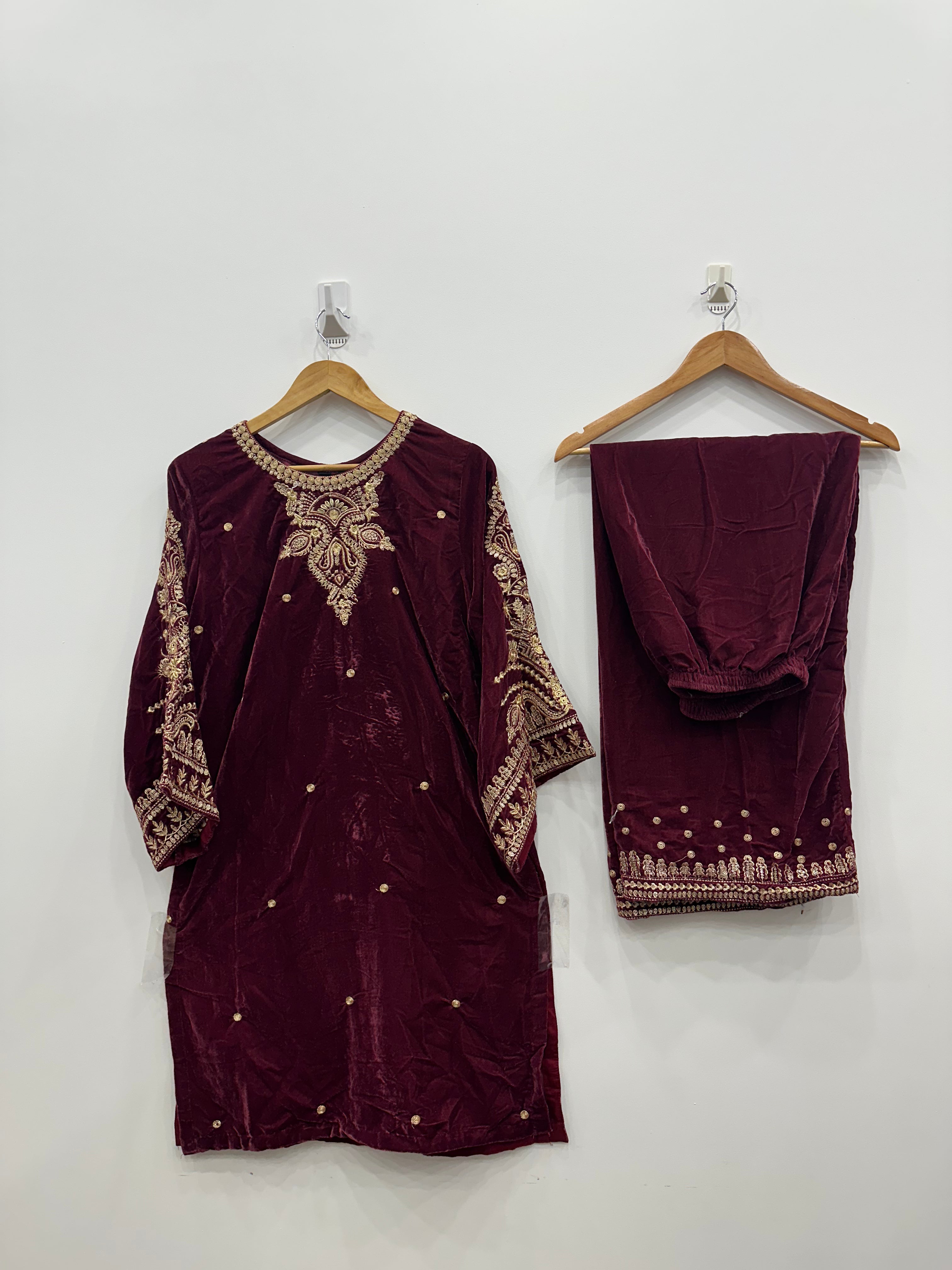 Maroon velvet embroidered kurta set with heavily embroidered neckline and sleeves, paired with matching embroidered velvet shawl and trousers