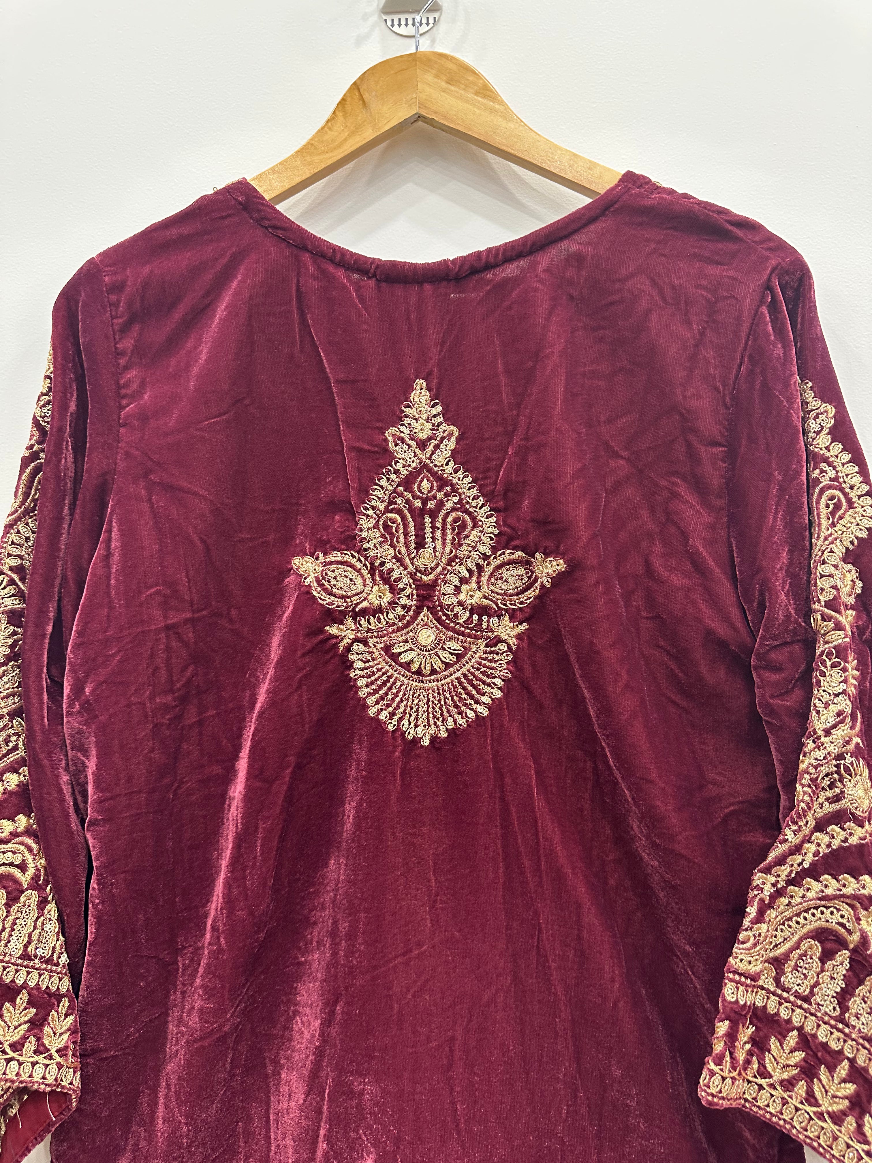 Back view of maroon velvet kurta featuring elegant embroidered motif and matching embroidered shaw