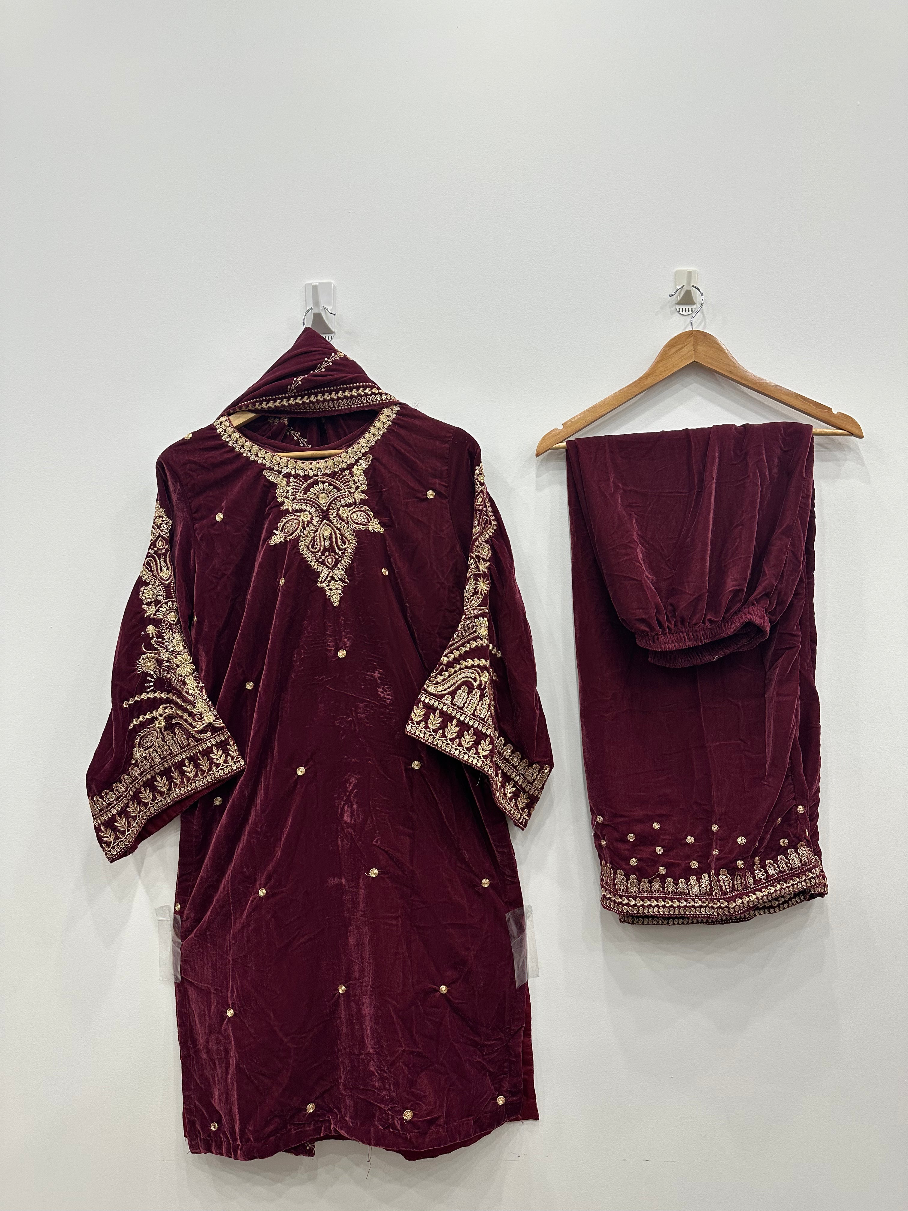 Maroon velvet embroidered kurta set with heavily embroidered neckline and sleeves, paired with matching embroidered velvet shawl and trousers