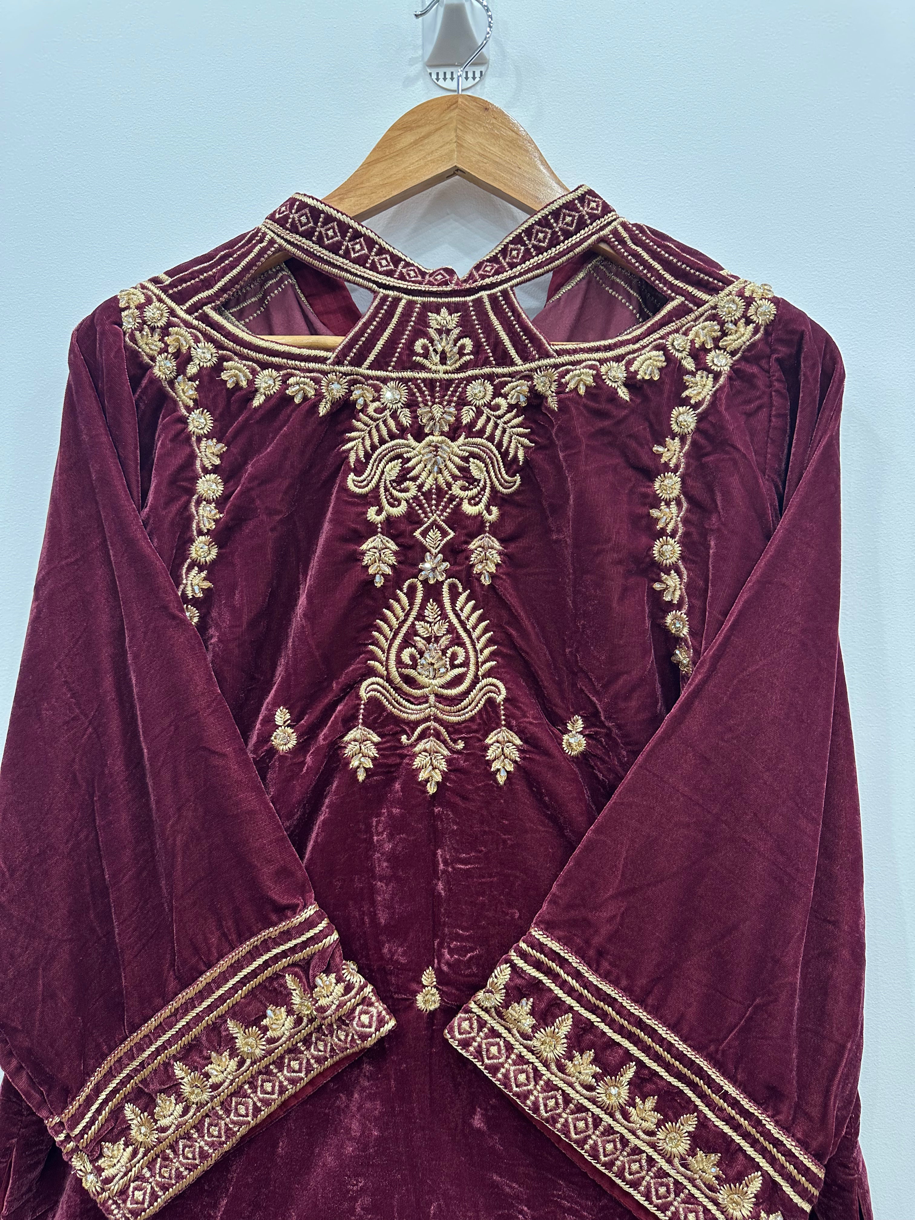 Close-up embroidery details on maroon velvet kurta neckline