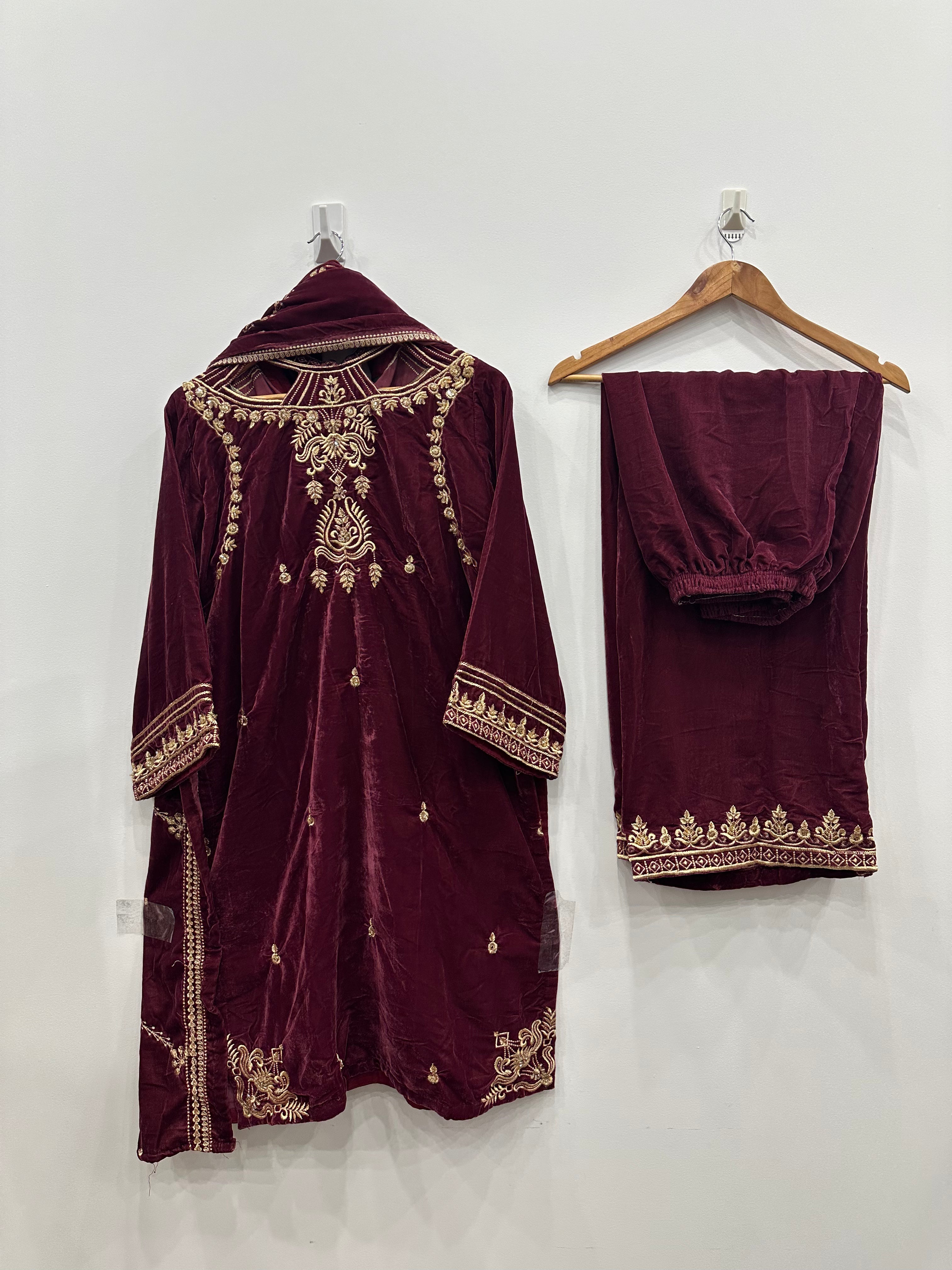 Maroon embroidered traditional outfit with dupatta on hangers against a white background