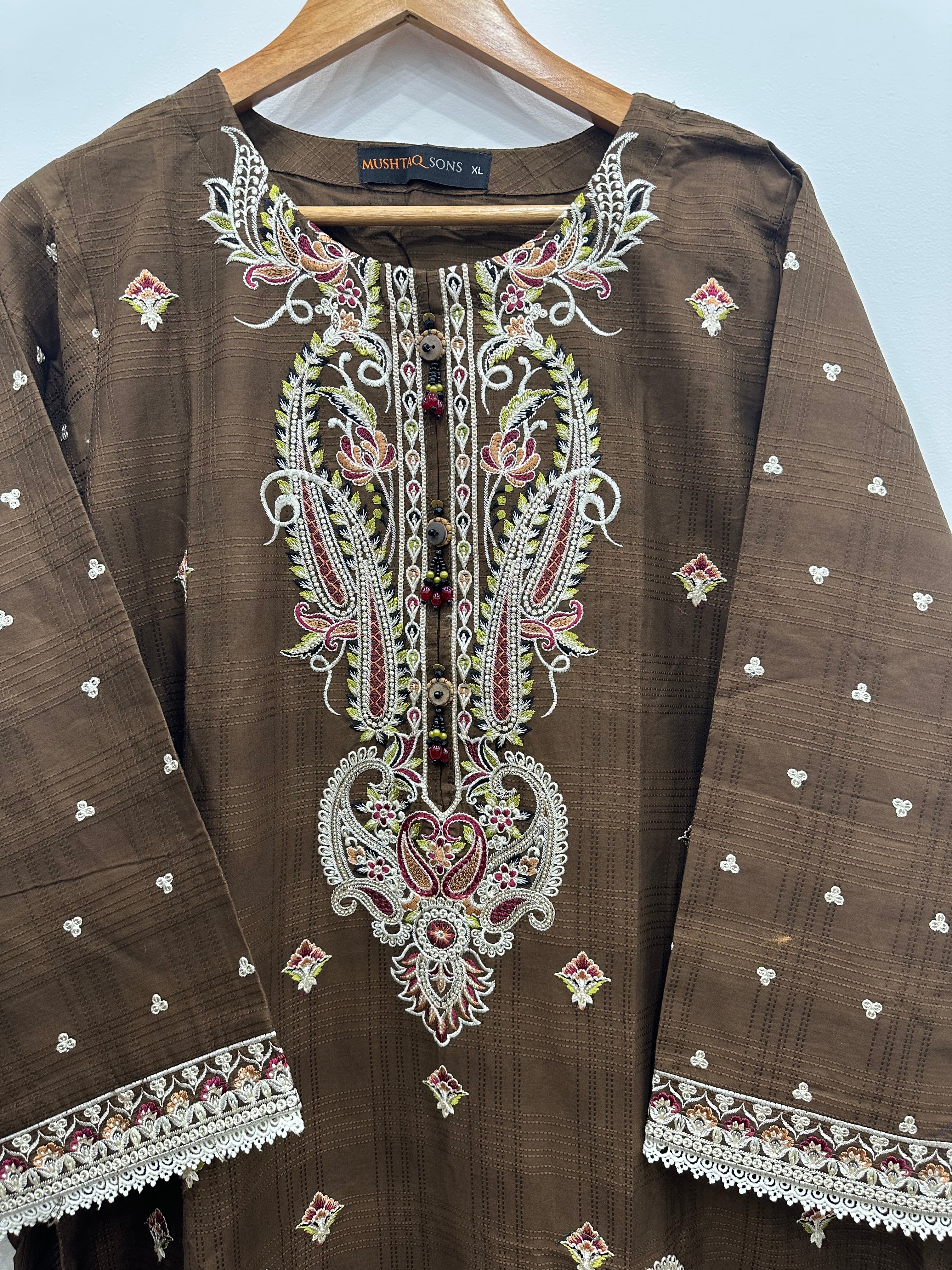 Close-up embroidery detail on brown slub cotton kurta