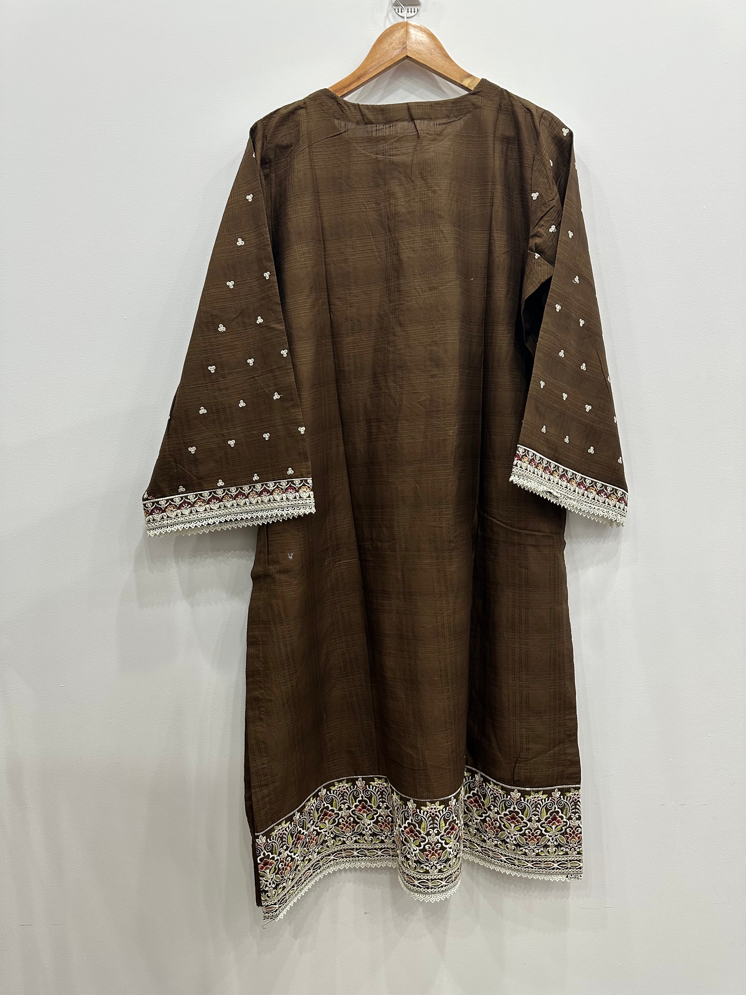 Brown traditional outfit with intricate white embroidery on a white background