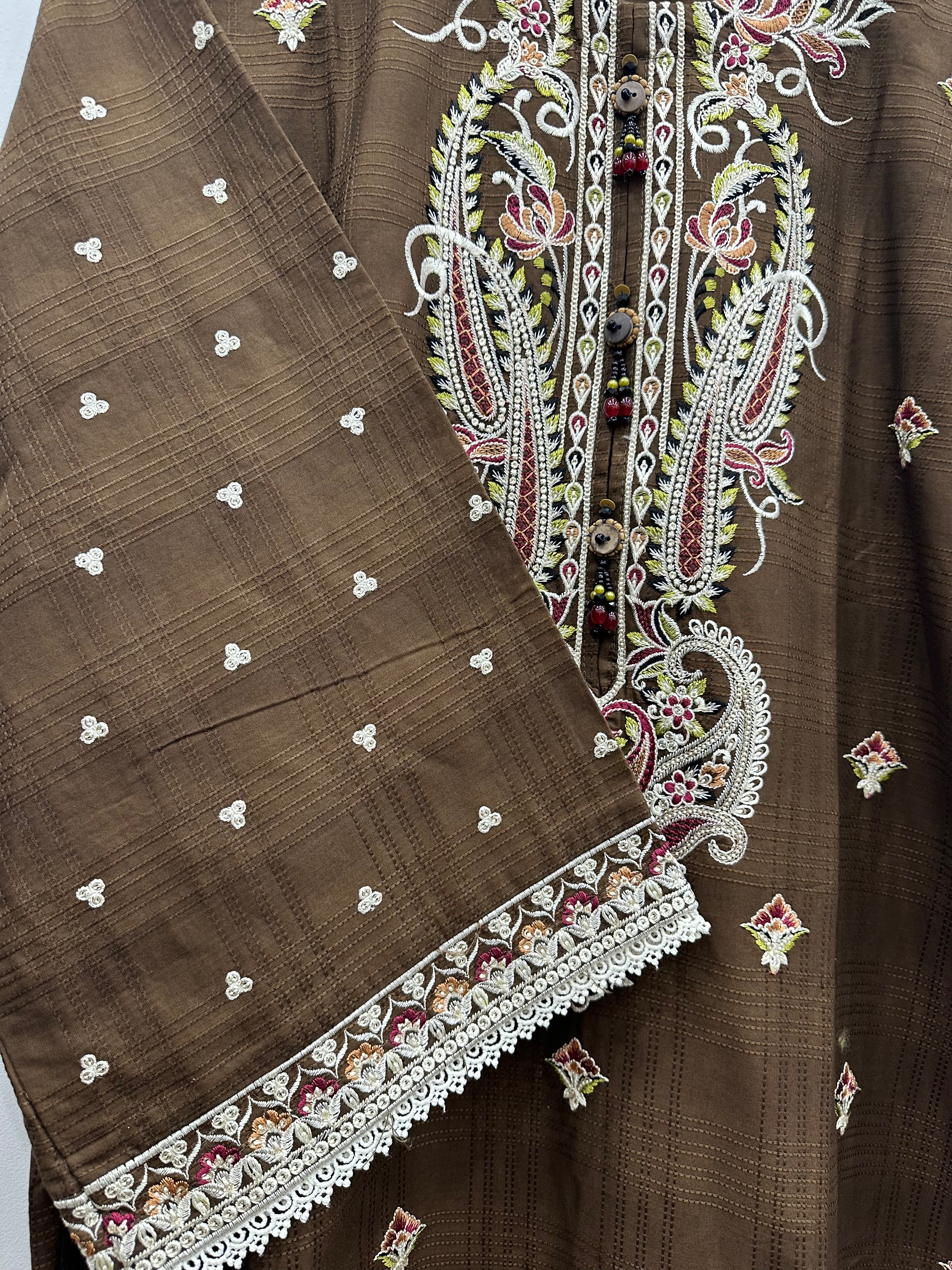 Close-up embroidery detail on brown slub cotton kurta