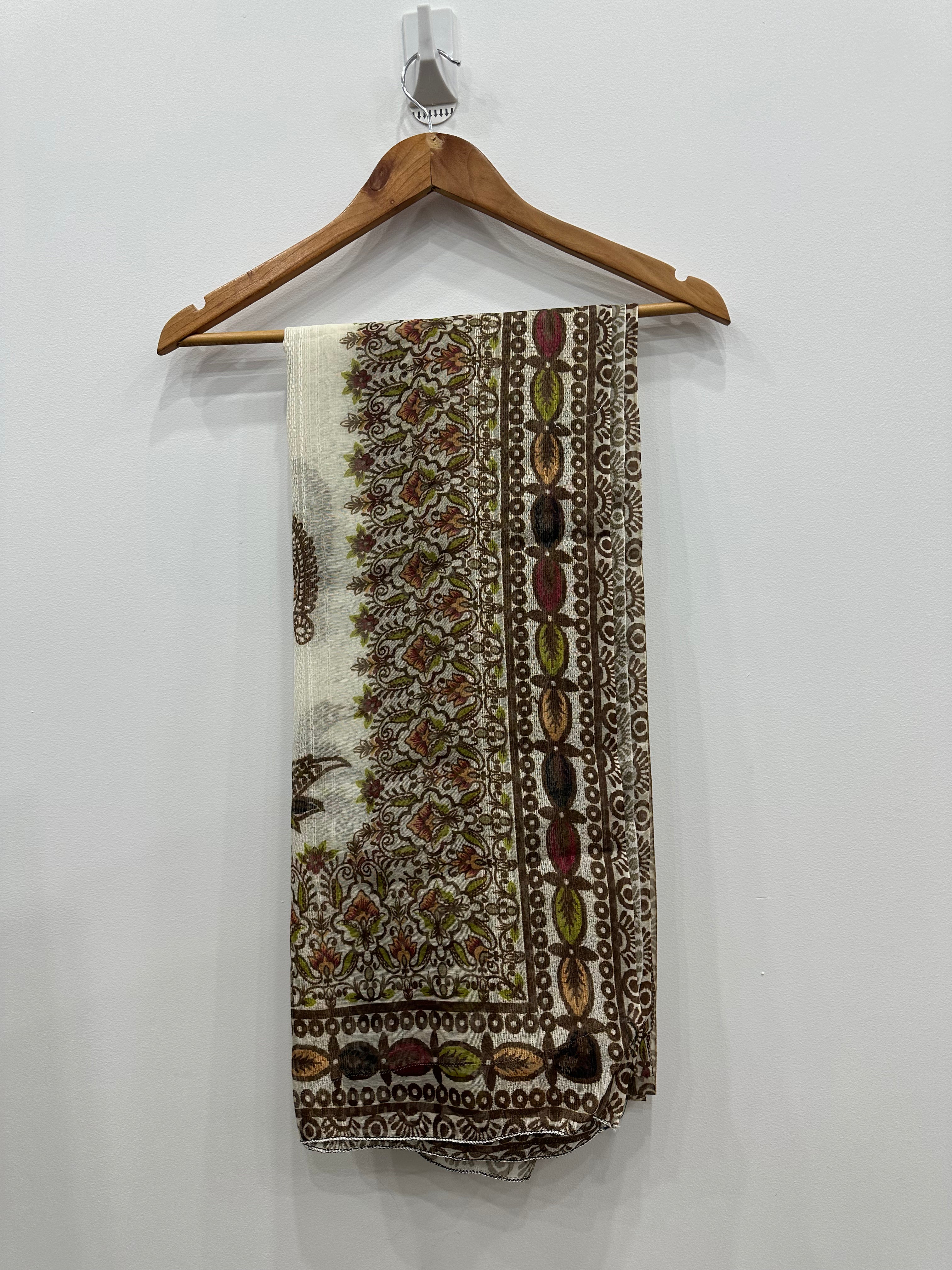 Patterned scarf on a wooden hanger against a white background