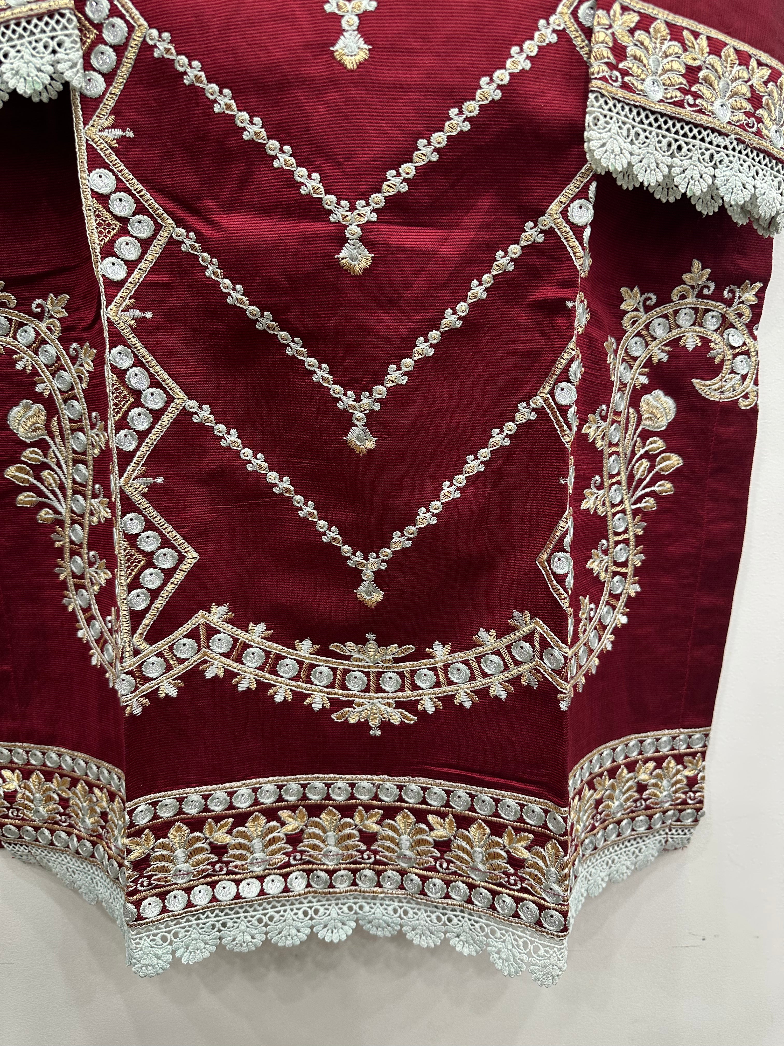 Close-up embroidery details on red khaddi net kurta