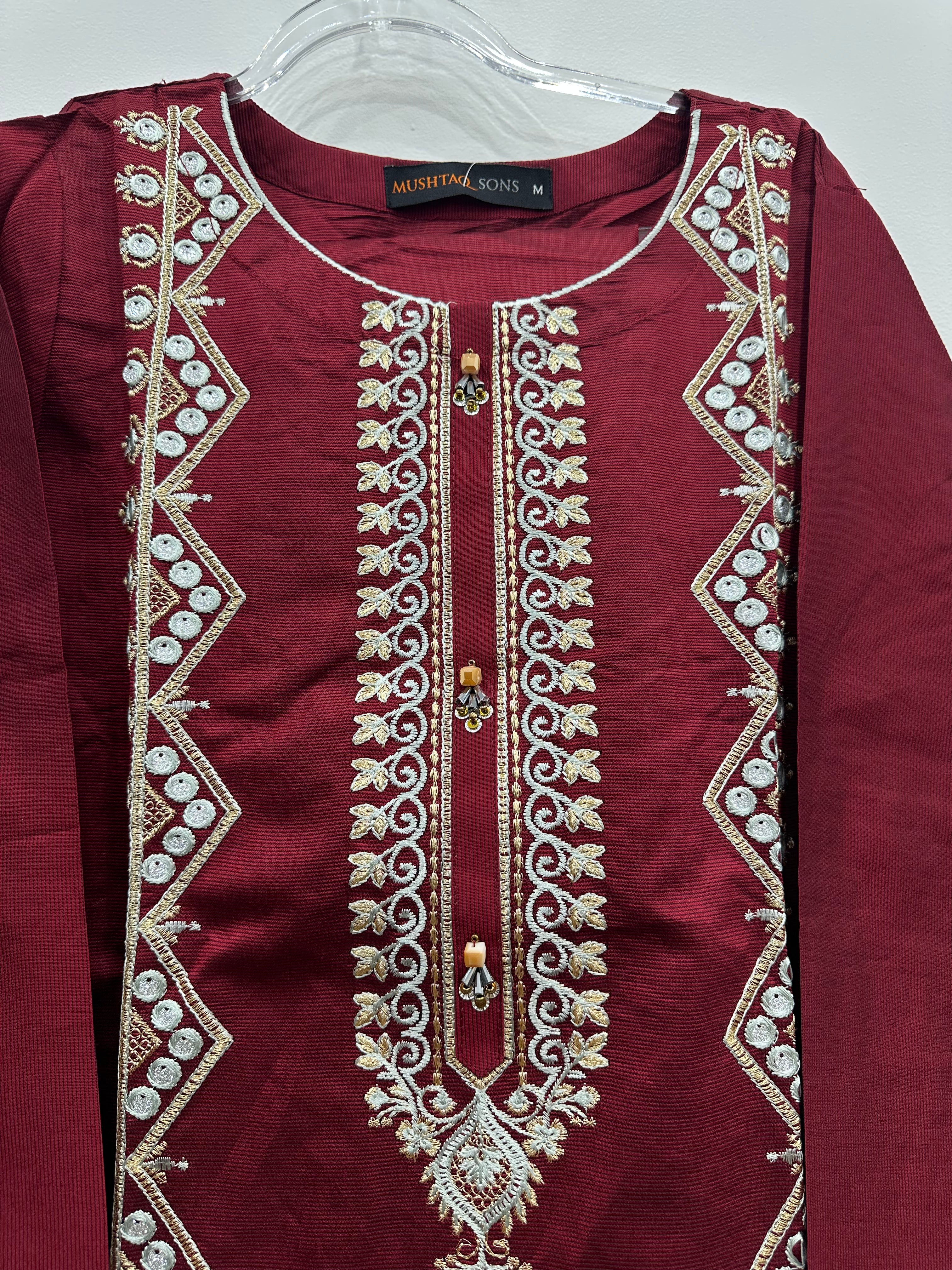 Close-up embroidery details on red khaddi net kurta