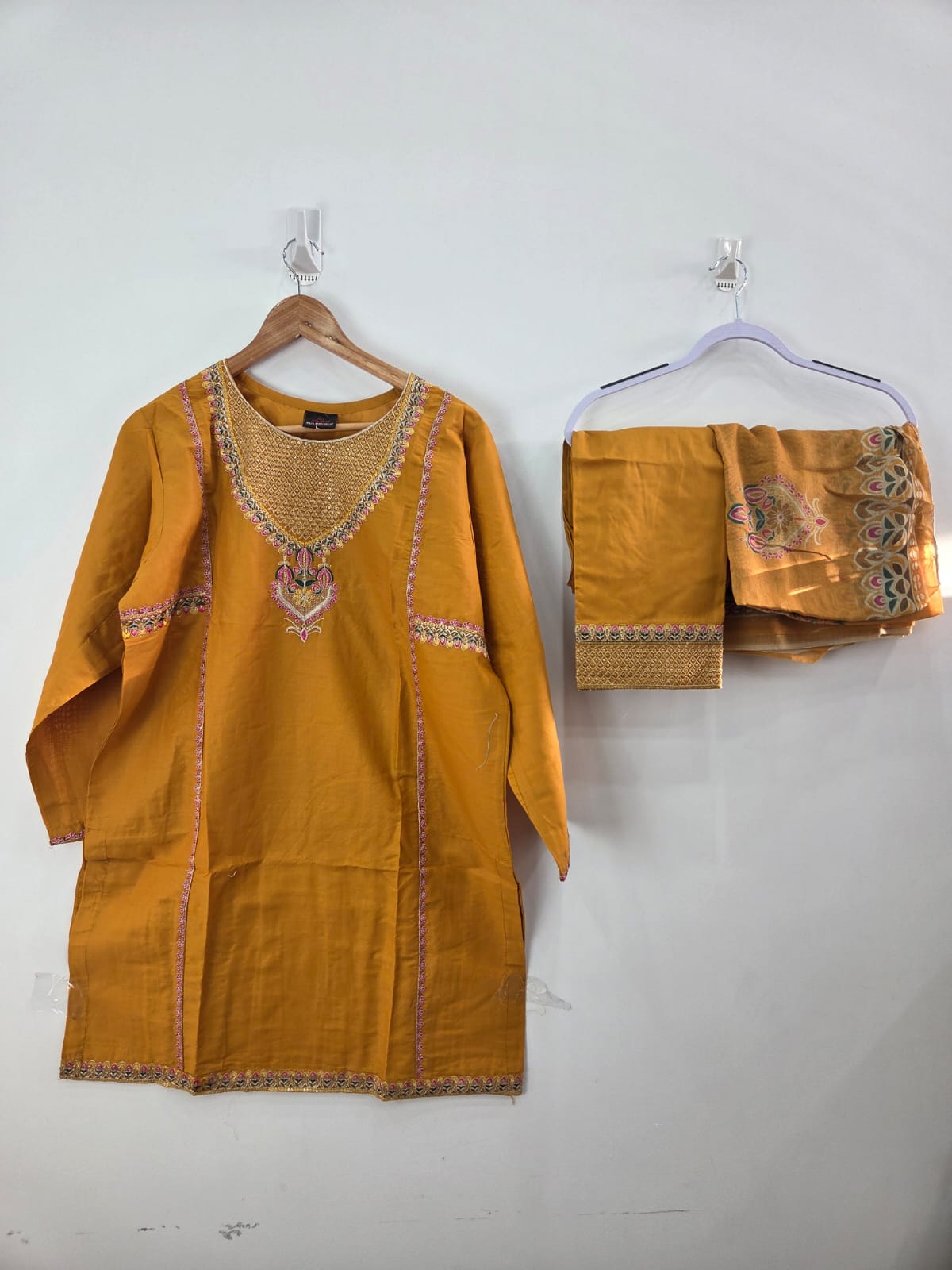 Mustard cotton lawn shirt with pink embroidery and tila work, paired with diamond dupatta