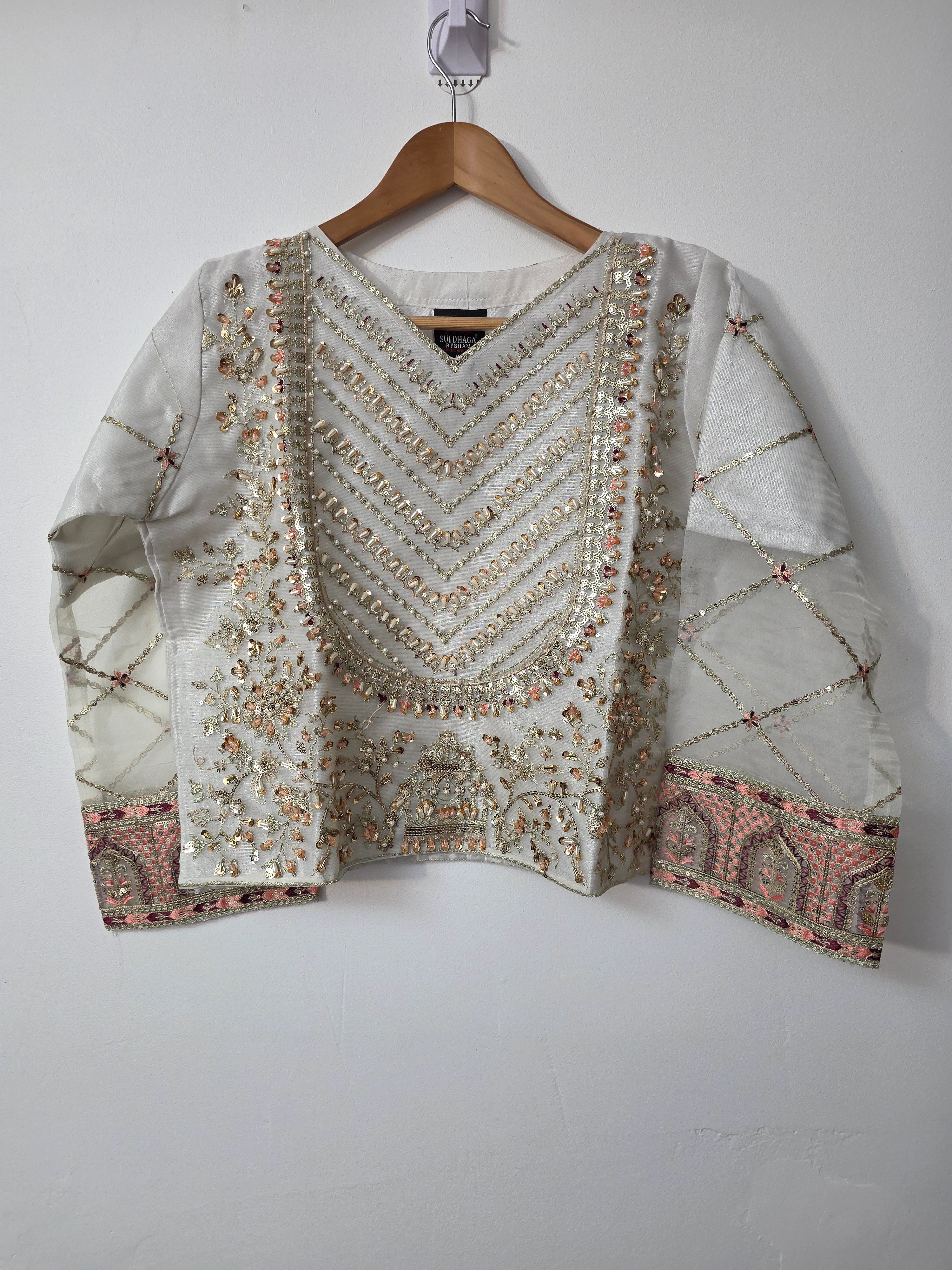 Off white Pakistani lehenga with pearl embellished choli
