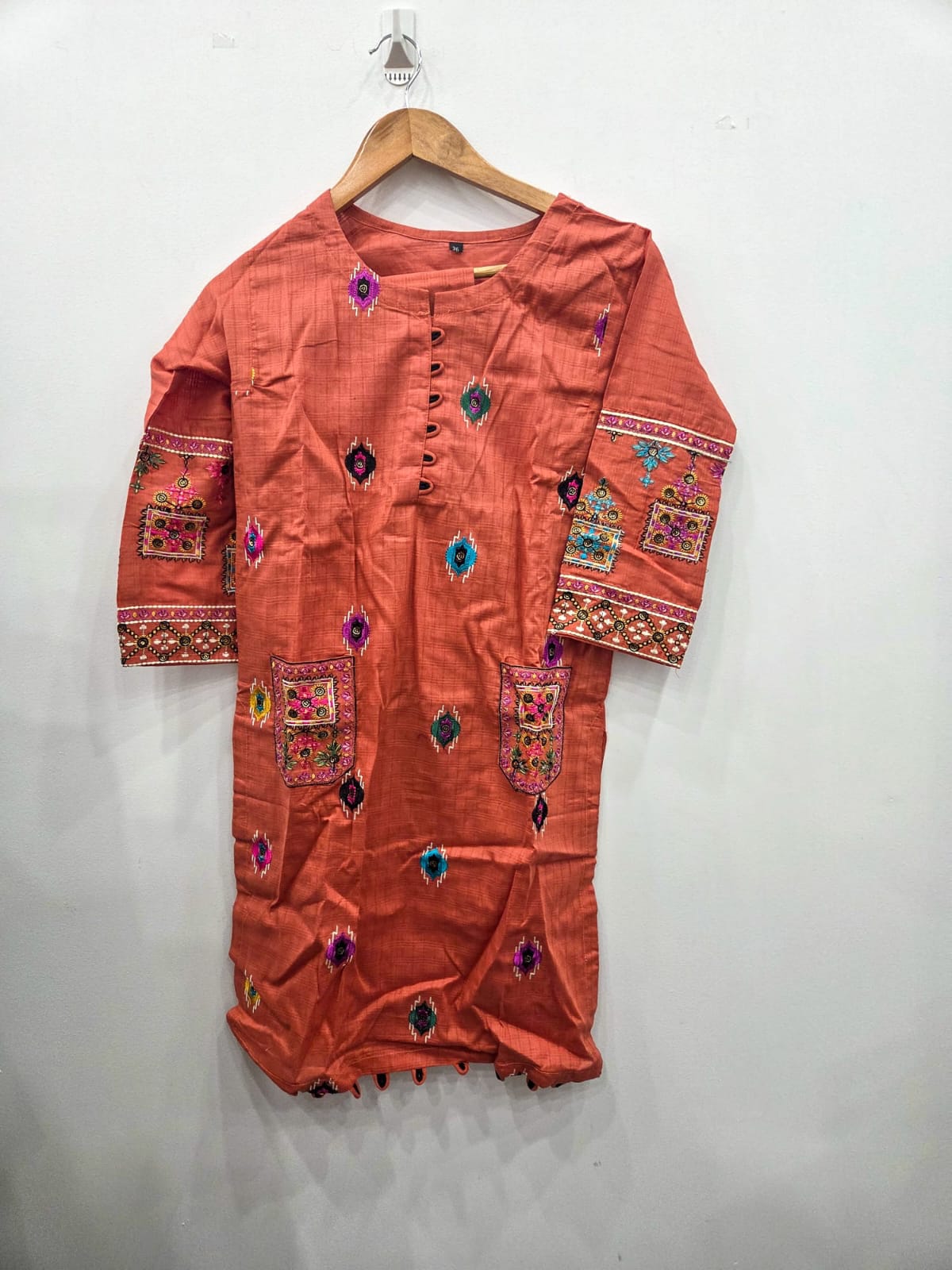 Peach 2 piece girls Pakistani suit with multicolor embroidered kurta, embroidered pockets