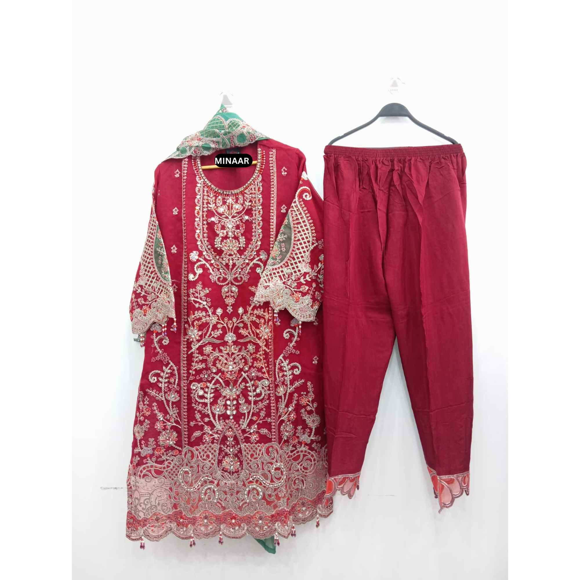 Red organza Pakistani 3 piece suit with heavy embroidery, stone work, green Khaddi Net dupatta and raw silk trouser