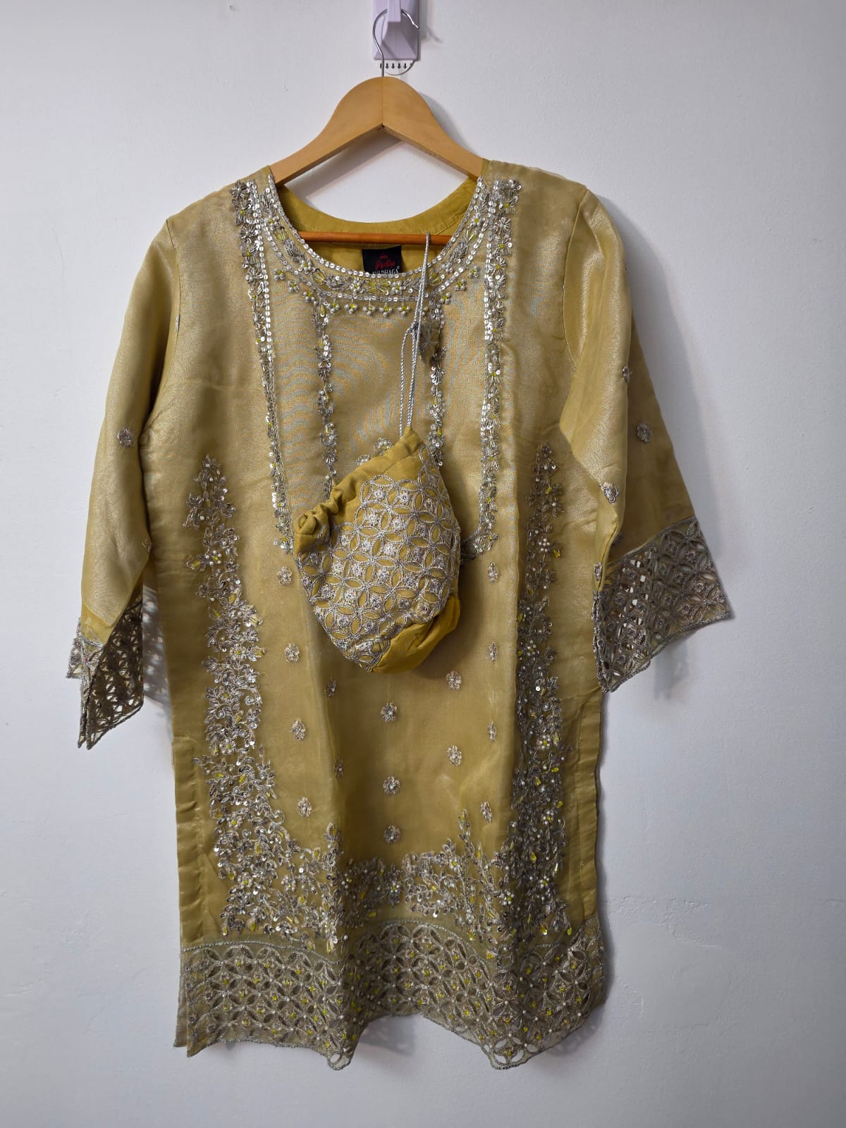 Yellow gold Pakistani sharara suit with Adda work embroidery, organza cutwork border and matching embroidered potli bag