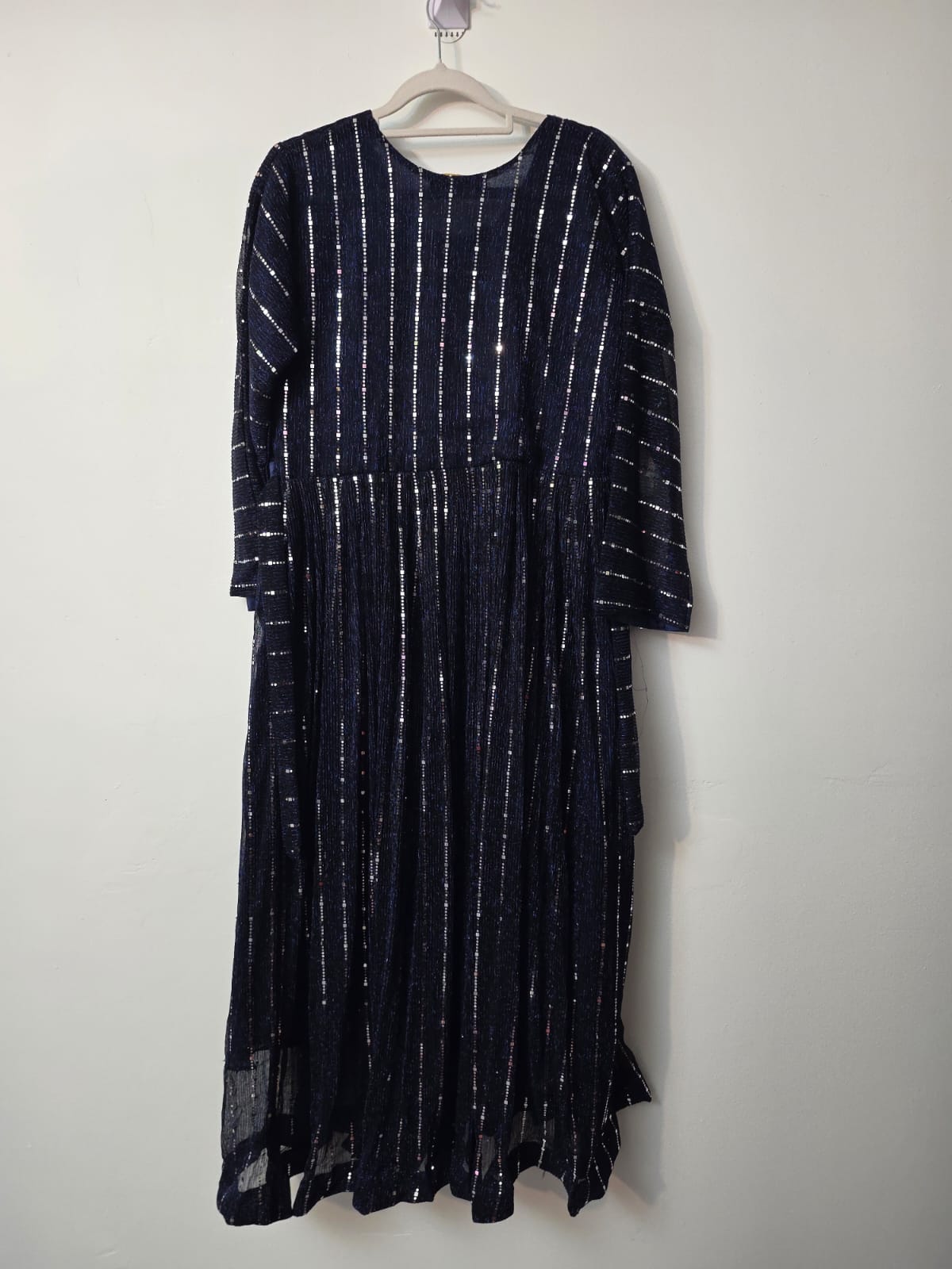 blue full length sequin shimmer maxi dress with long sleeves, decorative buttons and crystal embellished waist detail