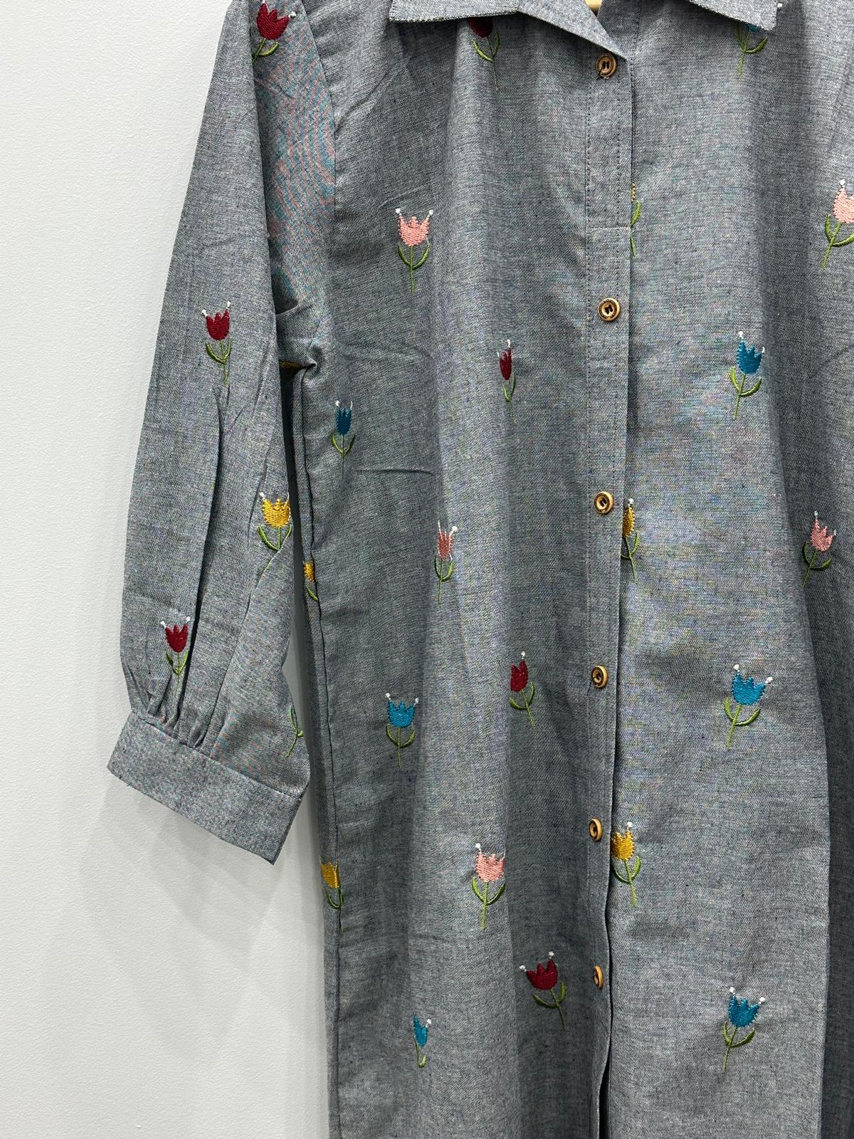 A gray long-sleeve button-up shirt dress with embroidered tulips in red, blue, yellow, and pink, displayed against a plain white background.